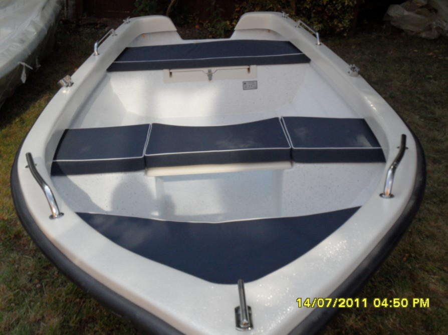 Welcome to our site, here you will find details of our new ELITE 390 open/day/fishing/outboard/rowing boat. With innovative features such as lifting centre seat with a flat double skinned floor beneath, a large rear hinged locker with fuel/battery cable vent built in and quality euro style rowlocks she is an elegant yet very practical boat and easy to maneuver around. At 13 foot (3.9metres) she is a real step up from the usual 8 foot - 12 foot dinghies, and with a fully piped quality 5-piece cushion set, heavy-duty storage cover and prcactical stainless handrails and cleats a very complete and competent craft. Fully CE approved, for a total crew capacity of 500kg and max outboard of 10hp she is perfect for lakes, broads, rivers and light estuary work. She has a raised bow, pleasing subtle simulated clinker design with a sharp V bow tapering of to a virtually flat rear for greater stabilty underway and also when still.